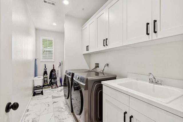 4203 Calle Del Vis, Oceanside, CA 92057 - washroom with washer and clothes dryer, cabinet space, light marble finish flooring, recessed lighting, and baseboards