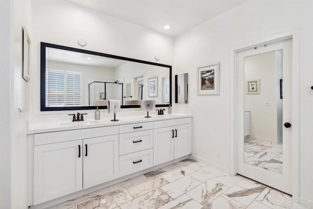 4203 Calle Del Vis, Oceanside, CA 92057 - full bathroom featuring marble look tiles, double vanity, a shower stall, baseboards, and healthy amount of natural light