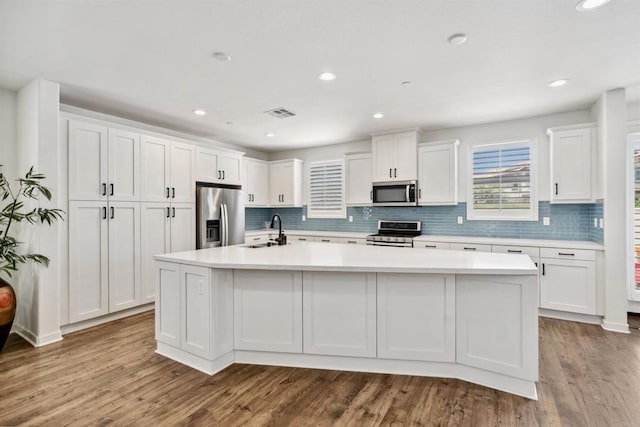 4203 Calle Del Vis, Oceanside, CA 92057 - kitchen featuring appliances with stainless steel finishes, a sink, white cabinets, a large island, and light countertops