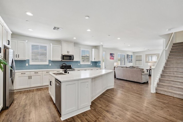 4203 Calle Del Vis, Oceanside, CA 92057 - kitchen featuring a sink, stainless steel appliances, an island with sink, light countertops, and white cabinets