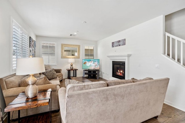 4203 Calle Del Vis, Oceanside, CA 92057 - living room with wood finished floors, a glass covered fireplace, baseboards, stairs, and recessed lighting