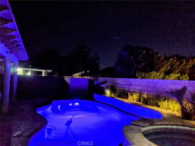 1800 Windermere Dr, Lancaster, CA 93534 - pool at night with an in-ground hot tub and a fenced backyard