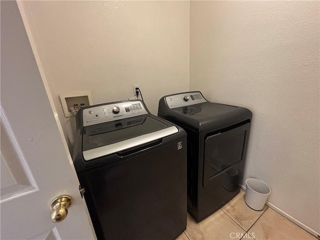 1800 Windermere Dr, Lancaster, CA 93534 - laundry area featuring washing machine and dryer and light tile patterned flooring