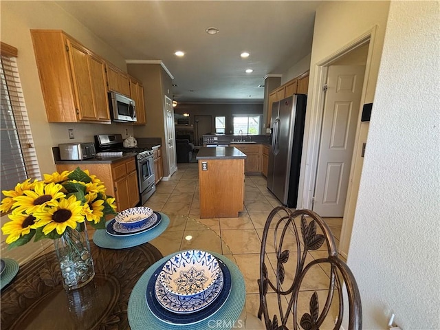 1800 Windermere Dr, Lancaster, CA 93534 - kitchen with stainless steel appliances, dark countertops, a kitchen island, recessed lighting, and a sink