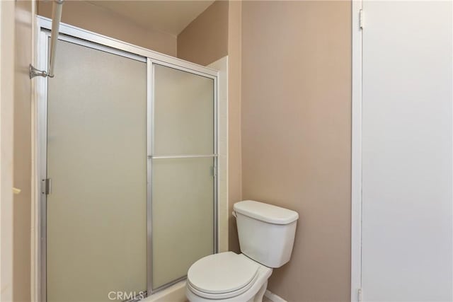 full bath with a shower stall and toilet