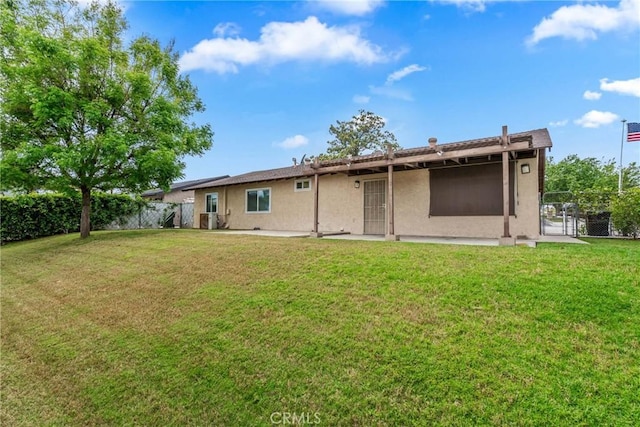 back of property with stucco siding and a gate