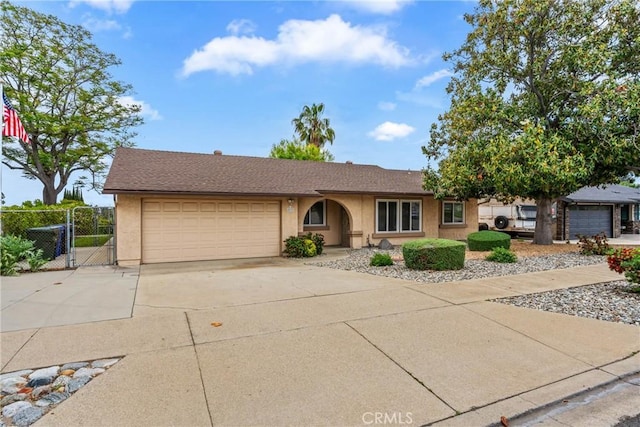 single story home with stucco siding, an attached garage, concrete driveway, a gate, and fence