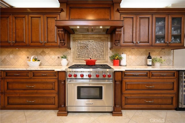 29784 Nautical Ct, Canyon Lake, CA 92587 - kitchen with premium stove, light tile patterned flooring, light stone countertops, and glass insert cabinets