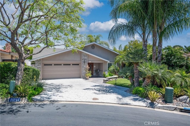 29784 Nautical Ct, Canyon Lake, CA 92587 - view of front of home featuring stone siding, stucco siding, a garage, and decorative driveway
