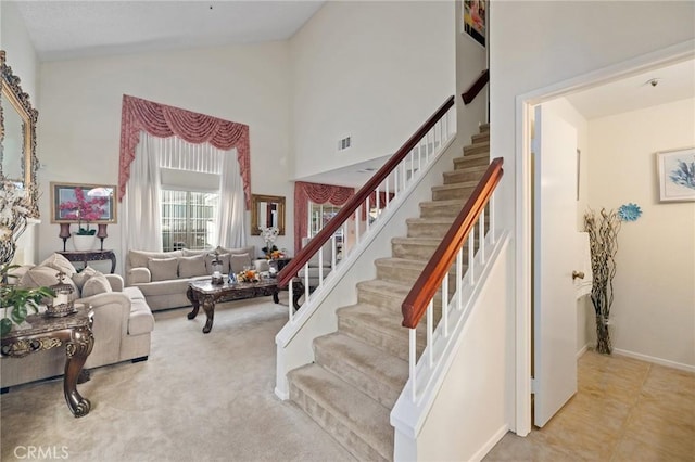 12018 Cherrywood Dr, Fontana, CA 92337 - staircase featuring high vaulted ceiling and baseboards