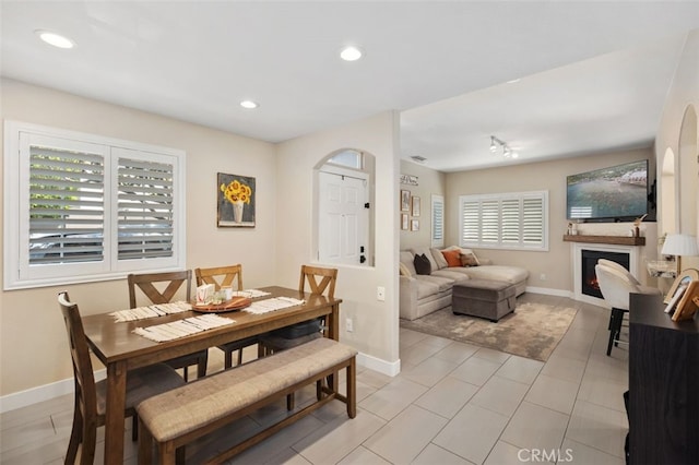 130 Bloomfield Ln, Rancho Santa Margarita, CA 92688 - dining area featuring baseboards, a warm lit fireplace, arched walkways, and recessed lighting