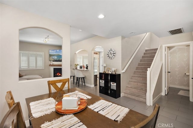 130 Bloomfield Ln, Rancho Santa Margarita, CA 92688 - tiled dining space with arched walkways, healthy amount of natural light, baseboards, stairway, and recessed lighting