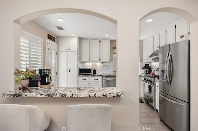 130 Bloomfield Ln, Rancho Santa Margarita, CA 92688 - kitchen with appliances with stainless steel finishes, under cabinet range hood, backsplash, white cabinets, and recessed lighting