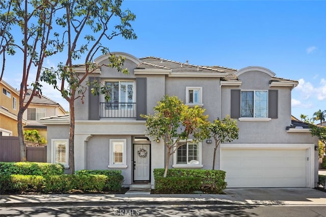 130 Bloomfield Ln, Rancho Santa Margarita, CA 92688 - view of front of home with an attached garage, driveway, stucco siding, and a balcony