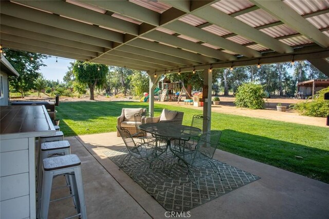 49 Bob Way, Oroville, CA 95965 - view of patio / terrace featuring a playground and outdoor dining area