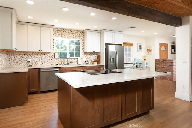 49 Bob Way, Oroville, CA 95965 - kitchen featuring appliances with stainless steel finishes, light wood-style floors, white cabinetry, tasteful backsplash, and a sink