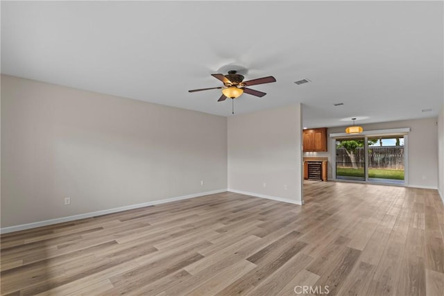 12705 Foreman Ave, Moreno Valley, CA 92553 - spare room with light wood finished floors, baseboards, and ceiling fan