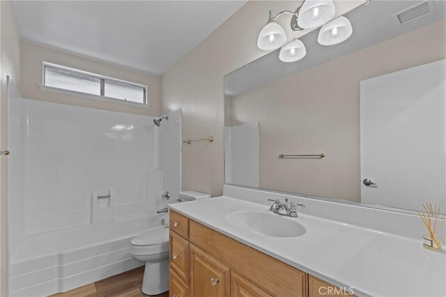 12705 Foreman Ave, Moreno Valley, CA 92553 - bathroom featuring toilet, vanity, shower / tub combination, and wood finished floors