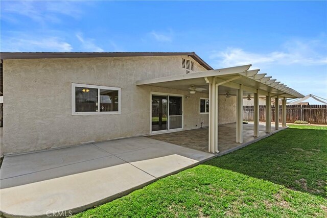 12705 Foreman Ave, Moreno Valley, CA 92553 - rear view of house with a ceiling fan, stucco siding, and a patio area