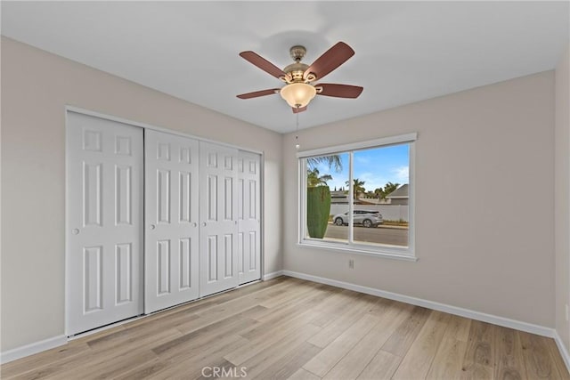 12705 Foreman Ave, Moreno Valley, CA 92553 - unfurnished bedroom with light wood finished floors, baseboards, a closet, and ceiling fan