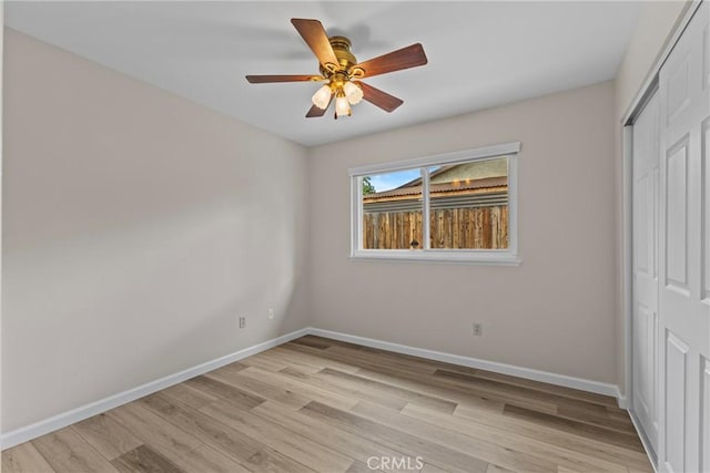 12705 Foreman Ave, Moreno Valley, CA 92553 - unfurnished bedroom with a closet, light wood-style floors, baseboards, and a ceiling fan