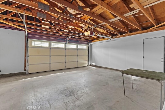 12705 Foreman Ave, Moreno Valley, CA 92553 - garage with a garage door opener and baseboards