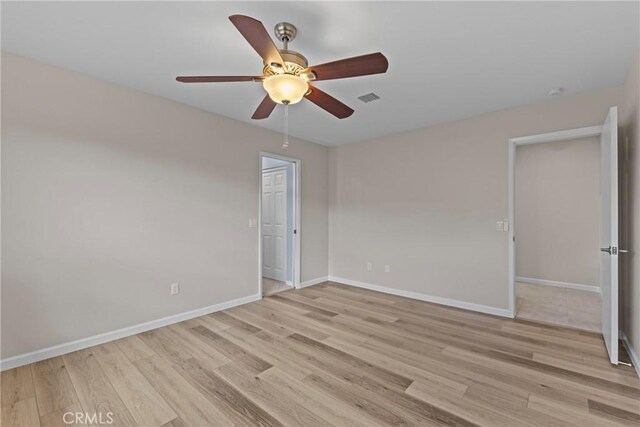 12705 Foreman Ave, Moreno Valley, CA 92553 - empty room with light wood finished floors, a ceiling fan, and baseboards