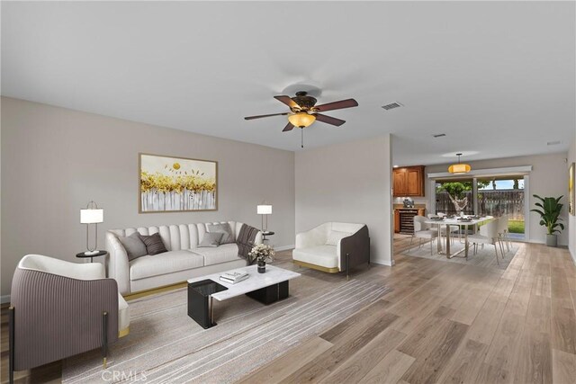 12705 Foreman Ave, Moreno Valley, CA 92553 - living room with a ceiling fan, light wood-style flooring, and baseboards