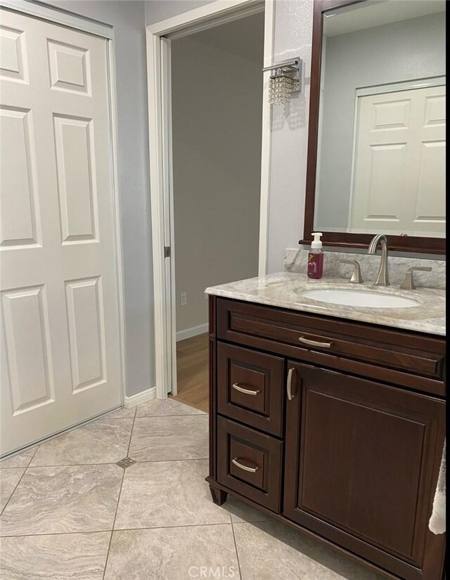 12705 Foreman Ave, Moreno Valley, CA 92553 - bathroom featuring vanity, tile patterned floors, and baseboards
