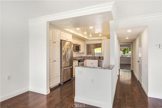4004 Calle Sonora Oeste Unit 1F, Laguna Woods, CA 92637 - kitchen with stainless steel appliances, crown molding, dark wood-type flooring, dark stone countertops, and a peninsula