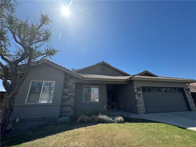4809 Prairie Meadows Way, Bakersfield, CA 93312 - view of front facade with stone siding, a garage, and a front yard