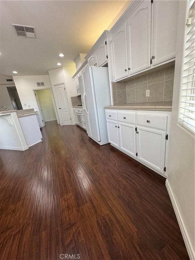 4809 Prairie Meadows Way, Bakersfield, CA 93312 - kitchen featuring white refrigerator with ice dispenser, dark wood-style flooring, tasteful backsplash, white cabinets, and recessed lighting
