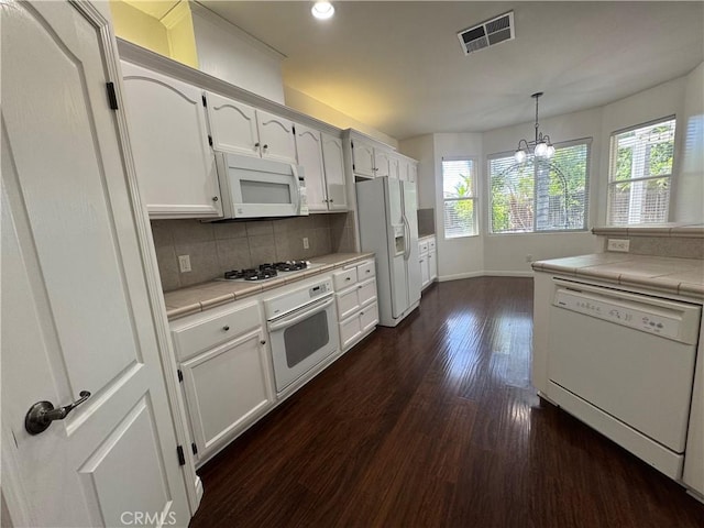 4809 Prairie Meadows Way, Bakersfield, CA 93312 - kitchen with white appliances, tile counters, dark wood-type flooring, a chandelier, and decorative backsplash
