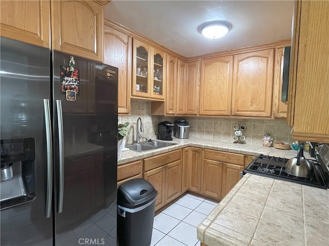 6 Rawhide Ln, Carson, CA 90745 - kitchen featuring stainless steel fridge, a sink, backsplash, and glass insert cabinets