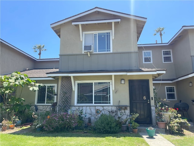 6 Rawhide Ln, Carson, CA 90745 - view of front of home with stucco siding, a front lawn, stone siding, and roof with shingles