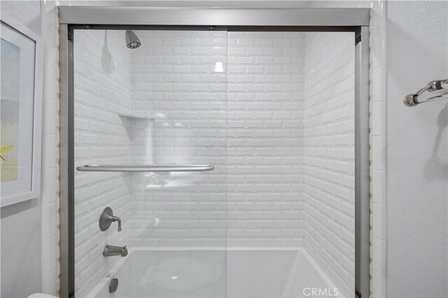 23423 Waterway Ln Unit 17, Valencia, CA 91355 - full bathroom with toilet, shower / bath combination with glass door, and a textured wall