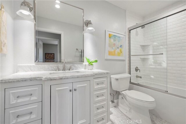 23423 Waterway Ln Unit 17, Valencia, CA 91355 - bathroom featuring toilet, vanity, and combined bath / shower with glass door