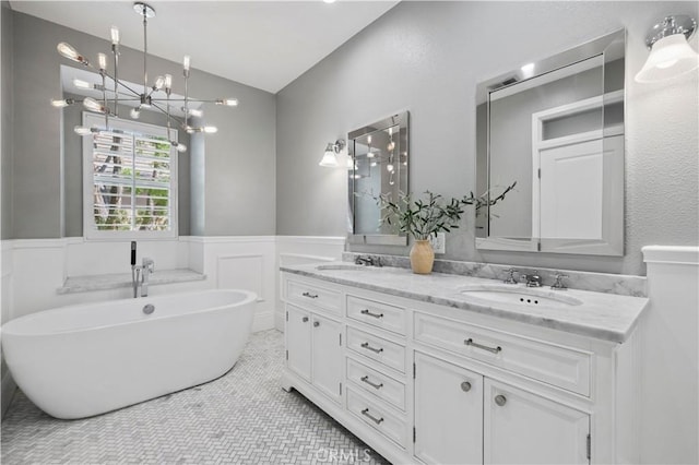 23423 Waterway Ln Unit 17, Valencia, CA 91355 - full bathroom with a chandelier, wainscoting, a soaking tub, double vanity, and lofted ceiling