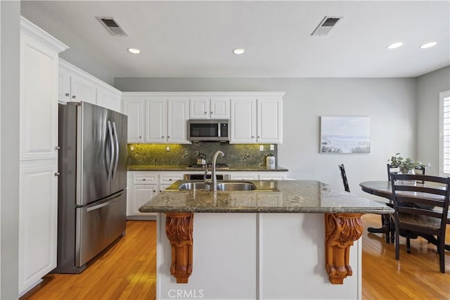 23423 Waterway Ln Unit 17, Valencia, CA 91355 - kitchen with stainless steel appliances, light wood-style flooring, white cabinetry, and recessed lighting