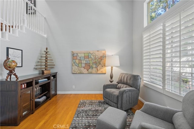 23423 Waterway Ln Unit 17, Valencia, CA 91355 - sitting room with light wood finished floors, a high ceiling, and baseboards