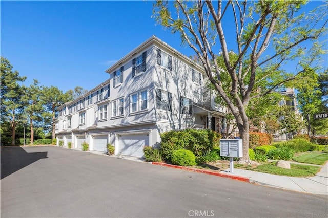 23423 Waterway Ln Unit 17, Valencia, CA 91355 - view of building exterior featuring an attached garage and driveway