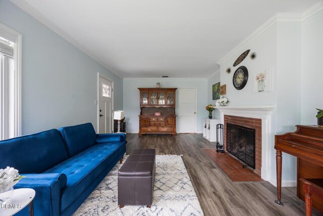 810 Selkirk St, Pasadena, CA 91103 - living room featuring wood finished floors, a brick fireplace, and ornamental molding