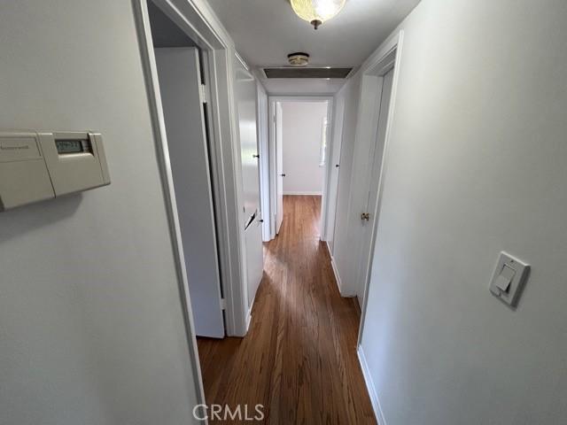 2020 W Swanee Ln, West Covina, CA 91790 - corridor featuring dark wood-style flooring and baseboards