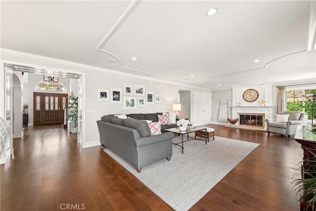 1280 Dumaine Ave, Oak Park, CA 91377 - living area featuring arched walkways, a glass covered fireplace, baseboards, recessed lighting, and dark wood-type flooring