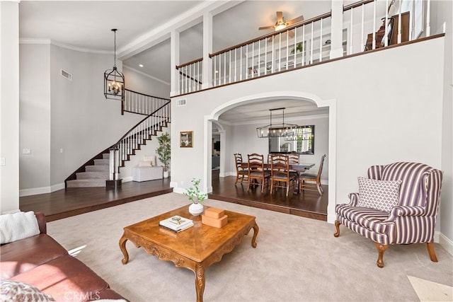 1280 Dumaine Ave, Oak Park, CA 91377 - living room with a ceiling fan, arched walkways, stairs, baseboards, and crown molding