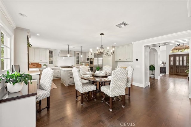 1280 Dumaine Ave, Oak Park, CA 91377 - dining space with arched walkways, a chandelier, crown molding, dark wood-style floors, and baseboards