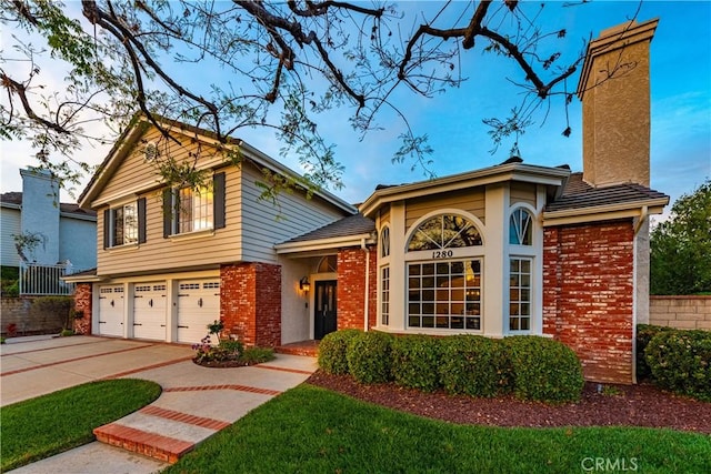 1280 Dumaine Ave, Oak Park, CA 91377 - view of front facade with brick siding, concrete driveway, a garage, and a chimney