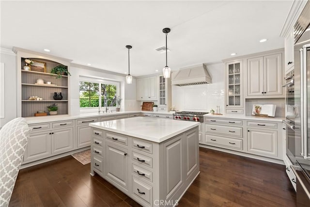 1280 Dumaine Ave, Oak Park, CA 91377 - kitchen featuring custom range hood, light countertops, dark wood finished floors, stainless steel gas stovetop, and ornamental molding