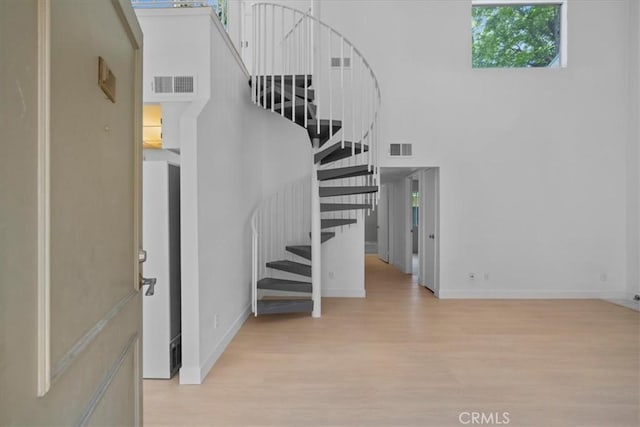 14937 Dickens St Unit 209, Sherman Oaks, CA 91403 - stairs with wood finished floors, baseboards, and a towering ceiling