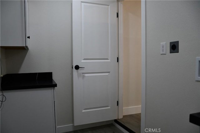 635 N Plumas St, Willows, CA 95988 - laundry area with electric dryer hookup, baseboards, and wood finished floors